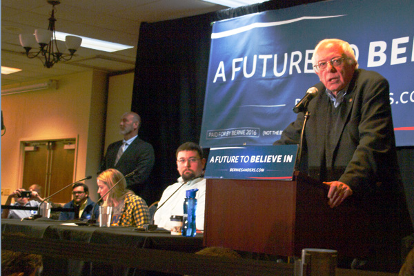 Image of presidential candidate Bernie Sanders speaking at a town hall.