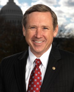 Head shot of Mark Kirk with Capitol in background