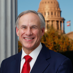 Governor Greg Abbott smiling in front of the Texas state legislature