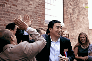 Yang smiles as he's surrounded by supporters