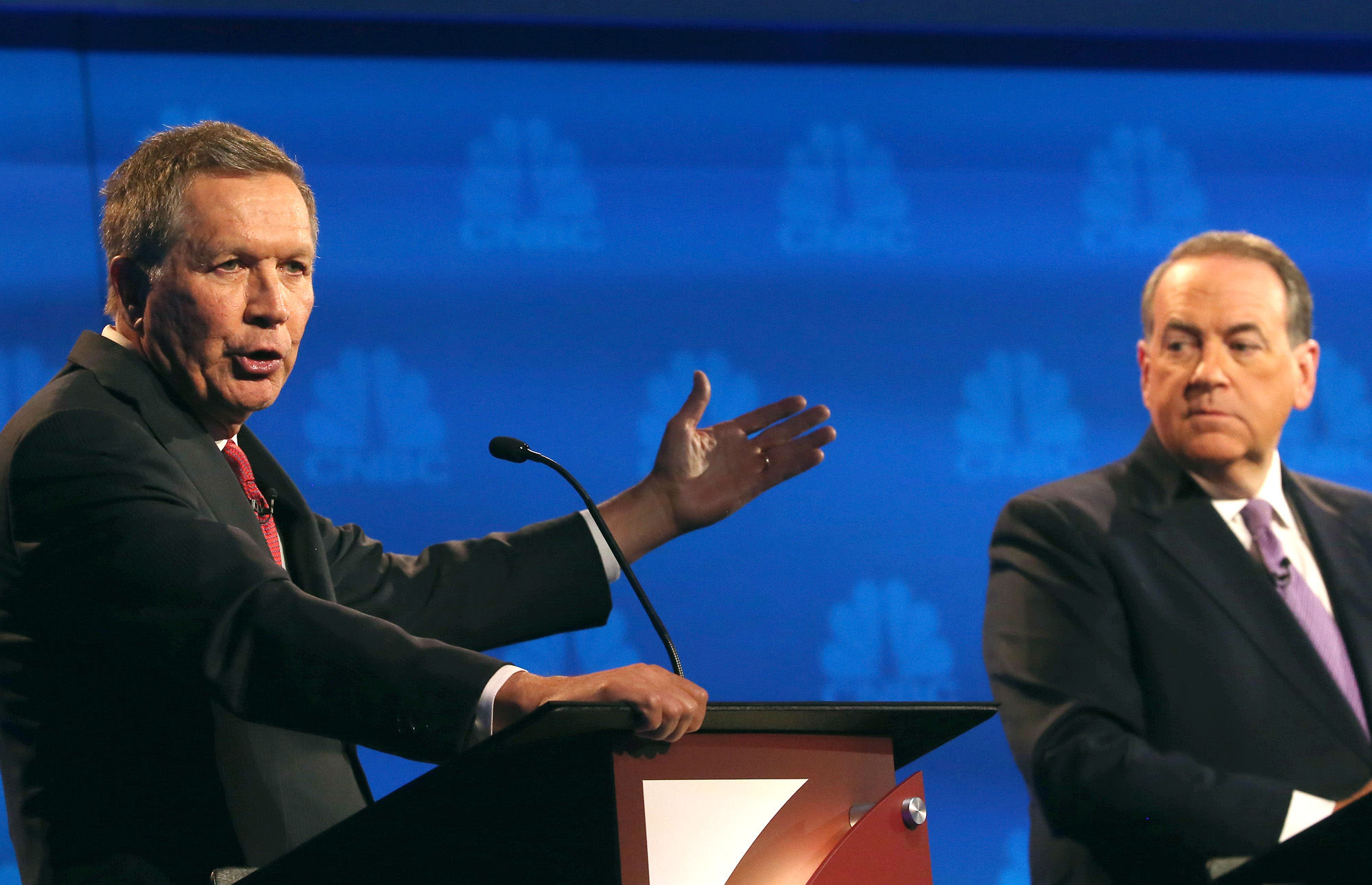 BOULDER, CO - OCTOBER 28: Presidential candidates Ohio Governor John Kasich (L-R) speaks while Mike Huckabee looks on during the CNBC Republican Presidential Debate at University of Colorados Coors Events Center October 28, 2015 in Boulder, Colorado. Fourteen Republican presidential candidates are participating in the third set of Republican presidential debates. (Photo by Justin Sullivan/Getty Images)
