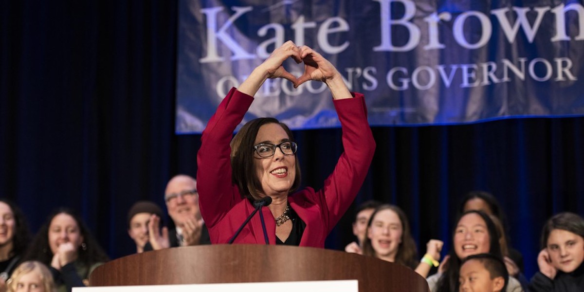 Kate Brown makes a hand heart sign at her victory party on election night