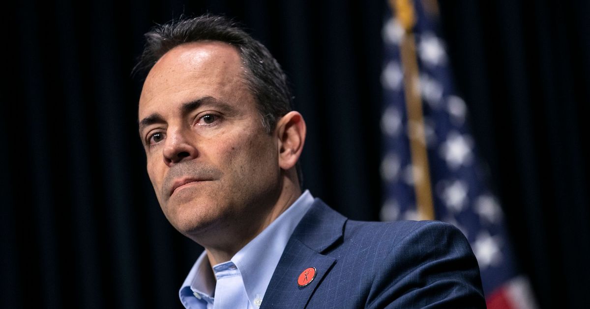 Kentucky Governor Matt Bevin stands in front of an American flag