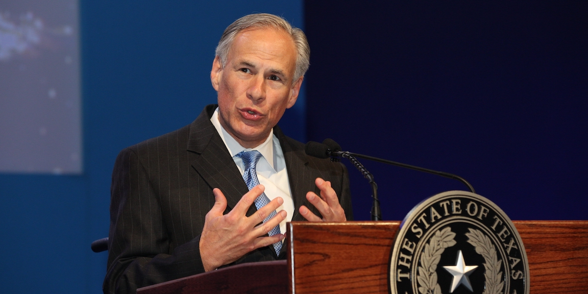 Governor Greg Abbott speaking behind a podium with the seal of the state of Texas on it
