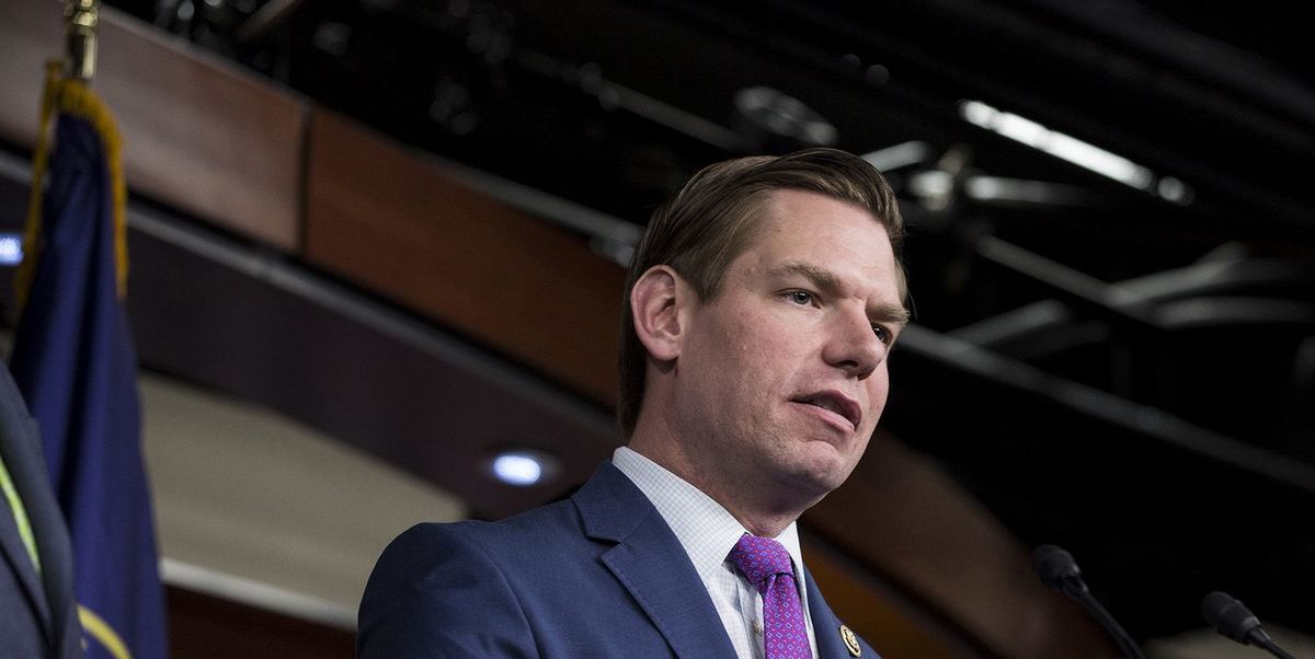 Eric Swalwell speaking to a crowd in a microphone.