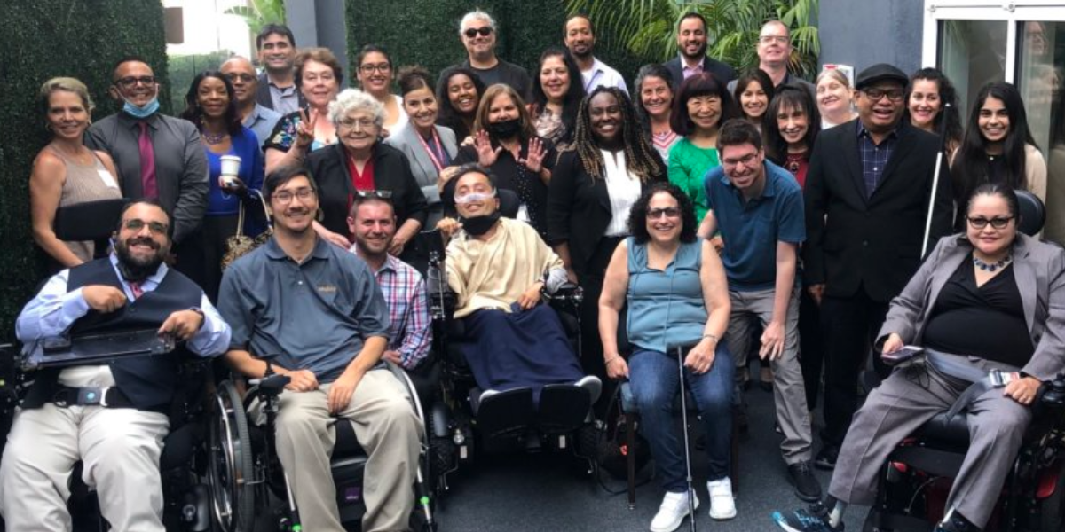 Attendees at a RespectAbility workforce event in California smile together